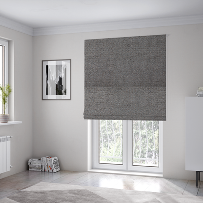 The fabric used to create these Roman blinds is a dark grey, textured upholstery fabric.