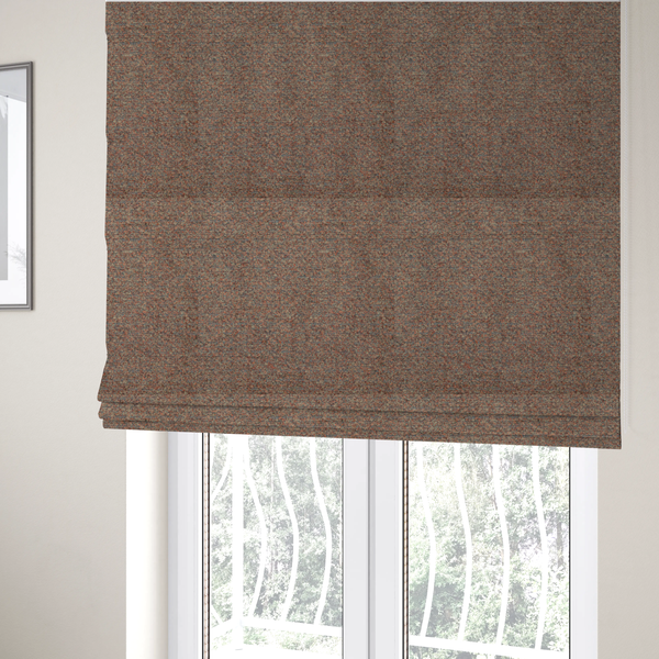 The fabric used to create these Roman blinds is a multi-toned orange and grey textured upholstery fabric.