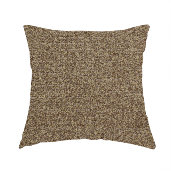 The fabric used to create this handmade cushion is a multi-toned golden brown, textured upholstery fabric.