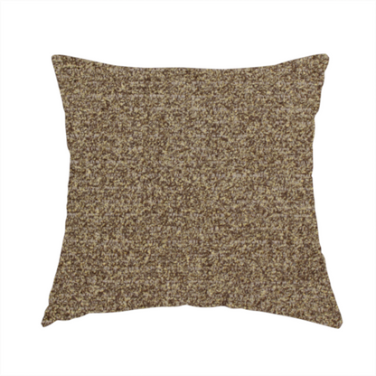 The fabric used to create this handmade cushion is a multi-toned golden brown, textured upholstery fabric.