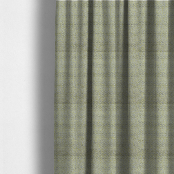 The fabric used to create these made-to-measure curtains is a multi-toned chartreuse green and grey textured upholstery fabric.