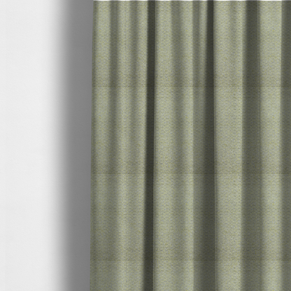 The fabric used to create these made-to-measure curtains is a multi-toned chartreuse green and grey textured upholstery fabric.