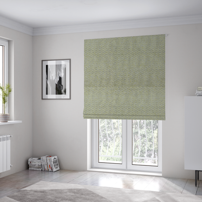 The fabric used to create these Roman blinds is a multi-toned chartreuse green and grey textured upholstery fabric.