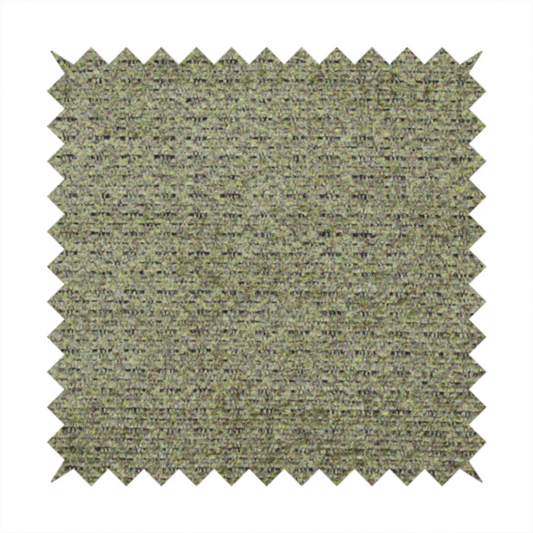 A multi-toned olive green textured upholstery fabric.