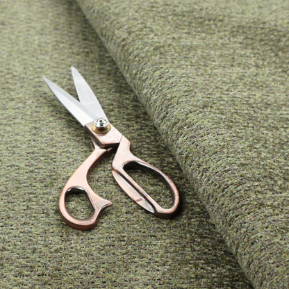 A multi-toned olive green textured upholstery fabric.