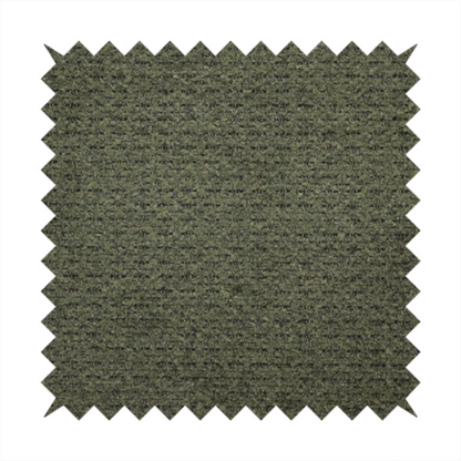 A dark forest green, heavily textured upholstery fabric.