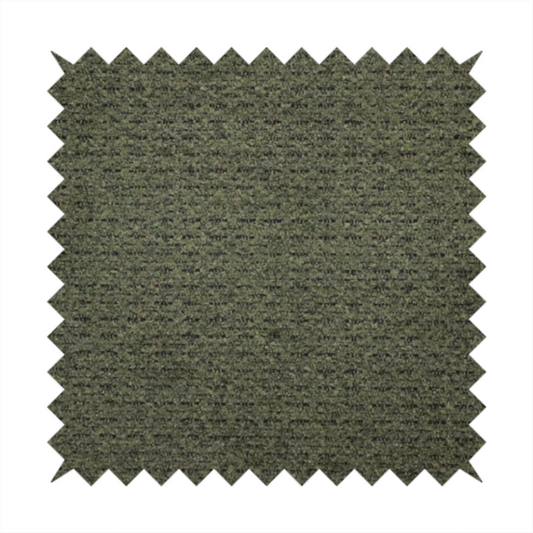 A dark forest green, heavily textured upholstery fabric.