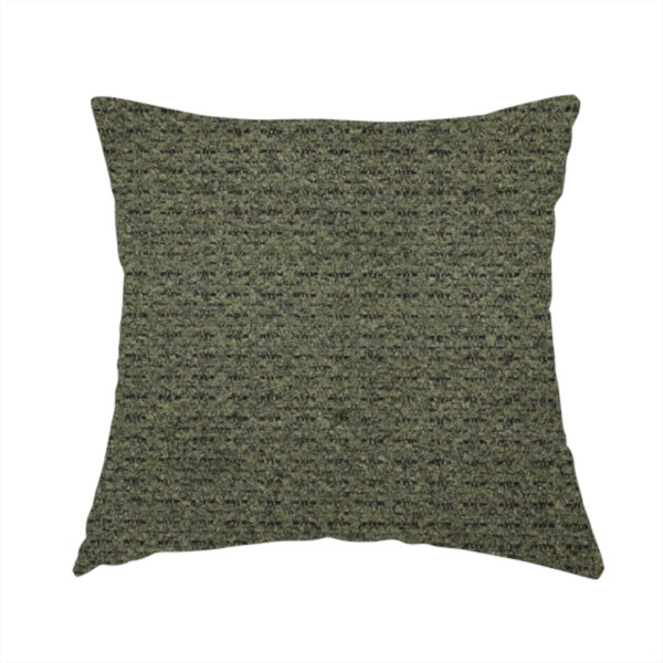 The fabric used to create this handmade cushion is a dark forest green, heavily textured upholstery fabric.