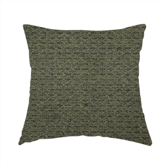 The fabric used to create this handmade cushion is a dark forest green, heavily textured upholstery fabric.