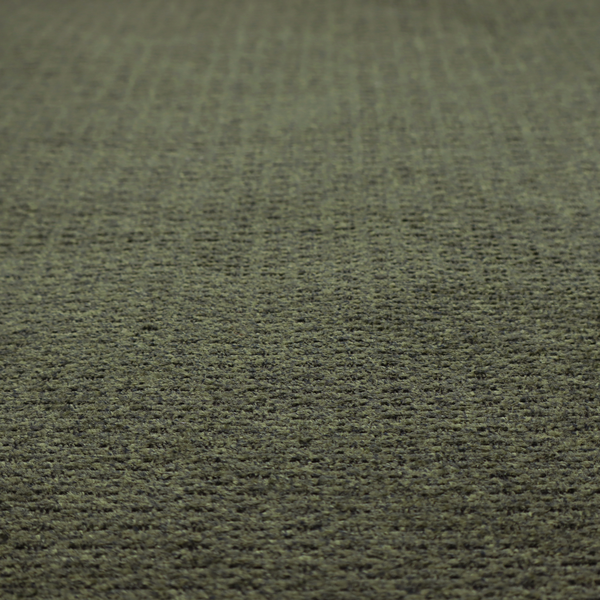 A dark forest green, heavily textured upholstery fabric.