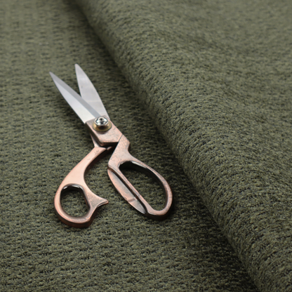 A dark forest green, heavily textured upholstery fabric.
