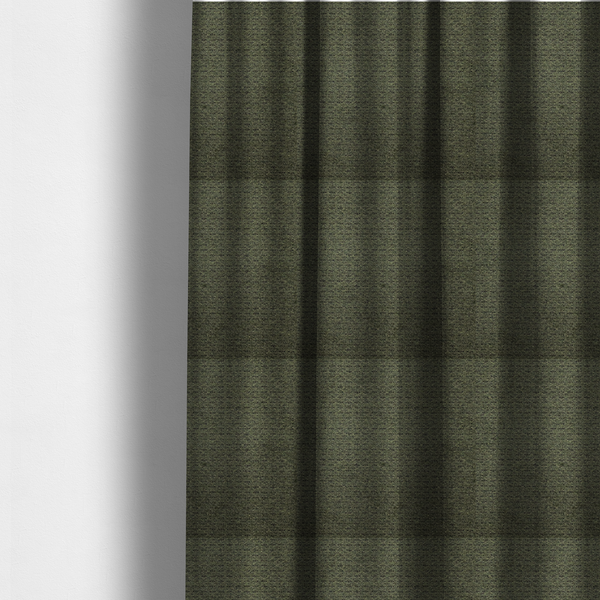 The fabric used to create these made-to-measure curtains is a dark forest green, heavily textured upholstery fabric.