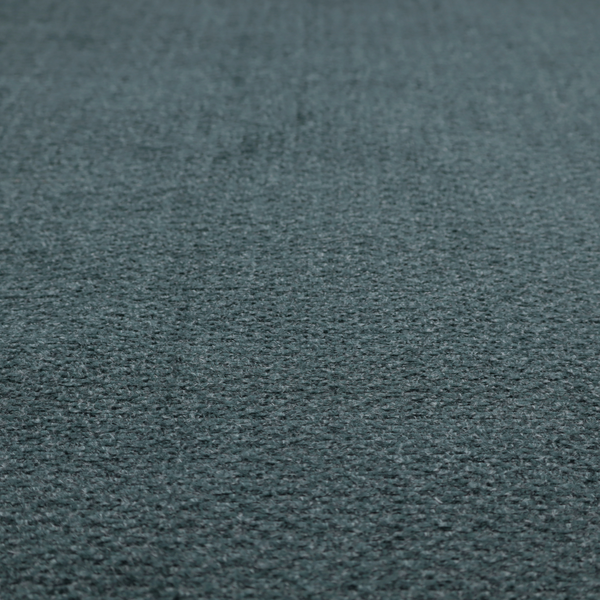 A dark teal or slate blue, textured upholstery fabric.
