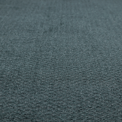 A dark teal or slate blue, textured upholstery fabric.