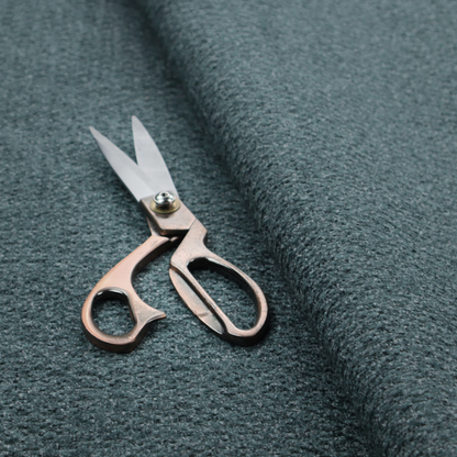 A dark teal or slate blue, textured upholstery fabric.