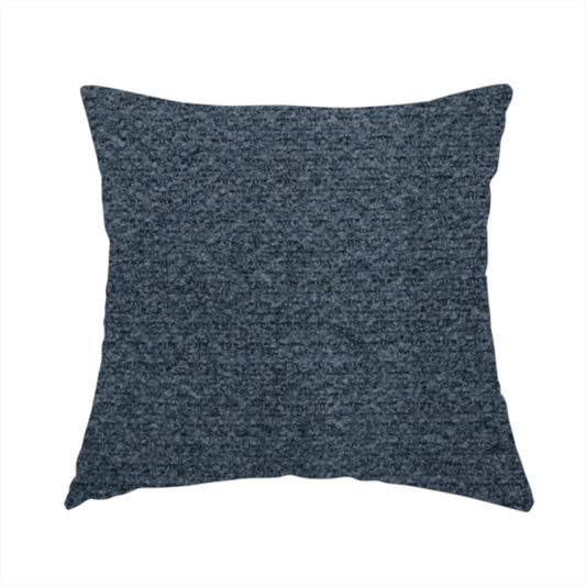 The fabric used to create this handmade cushion is a dark navy blue, heavily textured upholstery fabric.