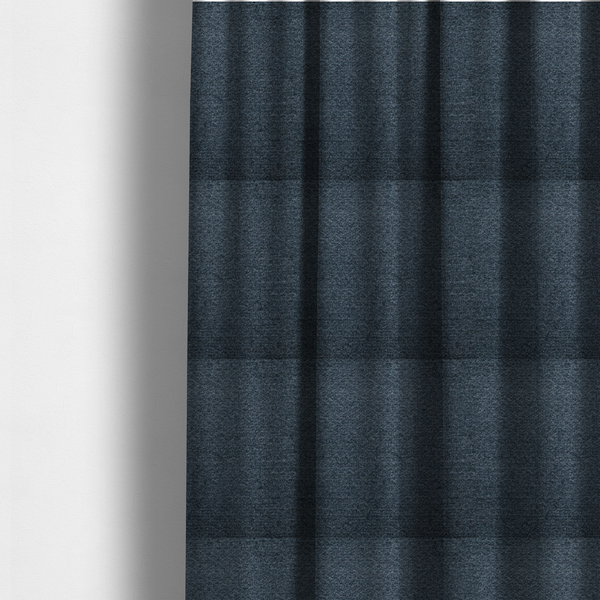 The fabric used to create these made-to-measure curtains is a dark navy blue, heavily textured upholstery fabric.
