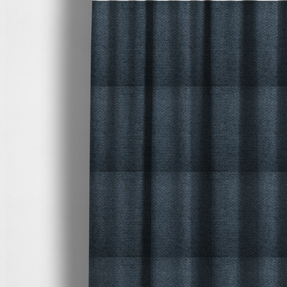 The fabric used to create these made-to-measure curtains is a dark navy blue, heavily textured upholstery fabric.