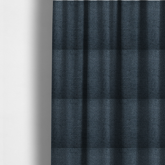 The fabric used to create these made-to-measure curtains is a dark navy blue, heavily textured upholstery fabric.