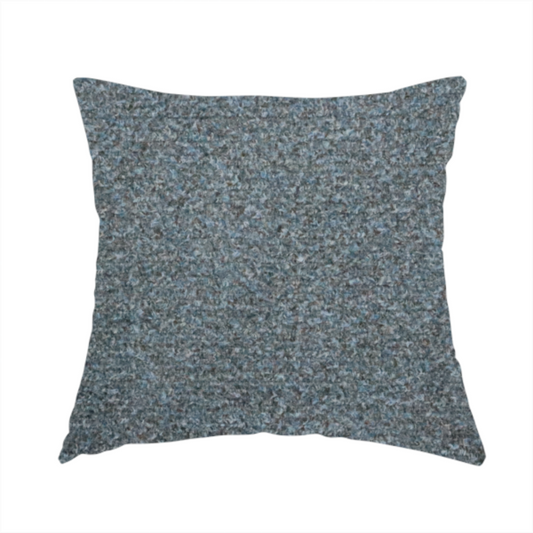 The fabric used to create this handmade cushion is a multi-toned steel blue and grey textured upholstery fabric.