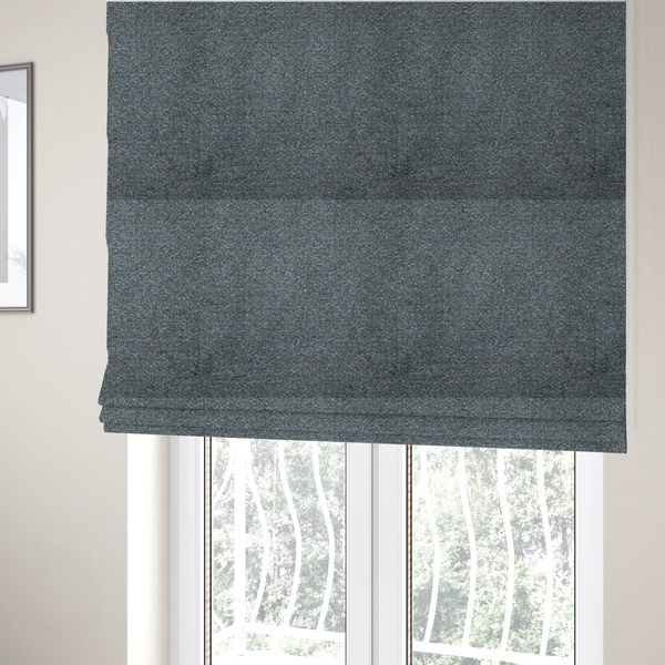 The fabric used to create these Roman blinds is a multi-toned steel blue and grey textured upholstery fabric.