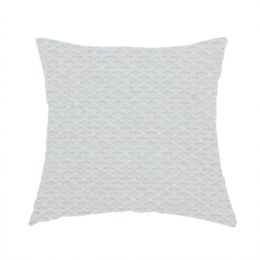 The fabric used to create this handmade cushion is a swatch of textured cream white upholstery fabric.