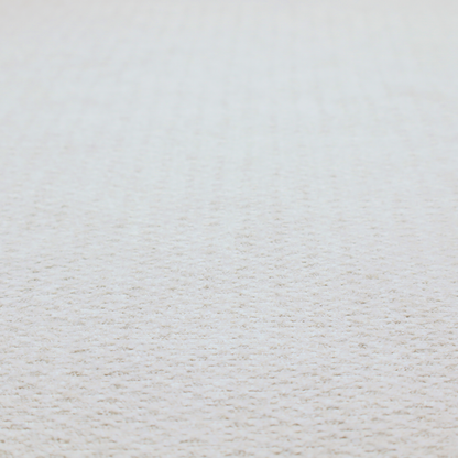 A swatch of textured cream white upholstery fabric.
