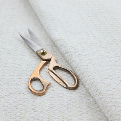 A swatch of textured cream white upholstery fabric.