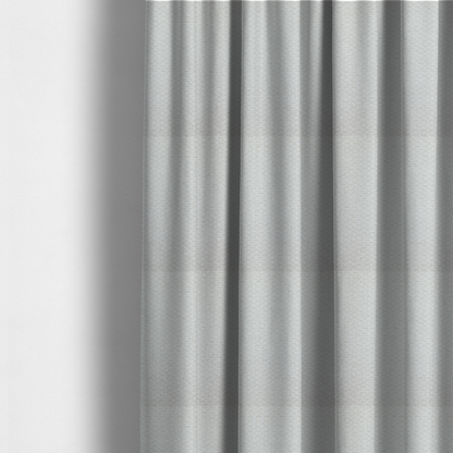 The fabric used to create these made-to-measure curtains is a swatch of textured cream white upholstery fabric.