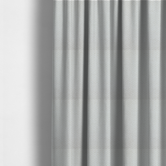 The fabric used to create these made-to-measure curtains is a swatch of textured cream white upholstery fabric.