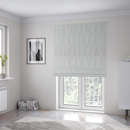 The fabric used to create these Roman blinds is a swatch of textured cream white upholstery fabric.