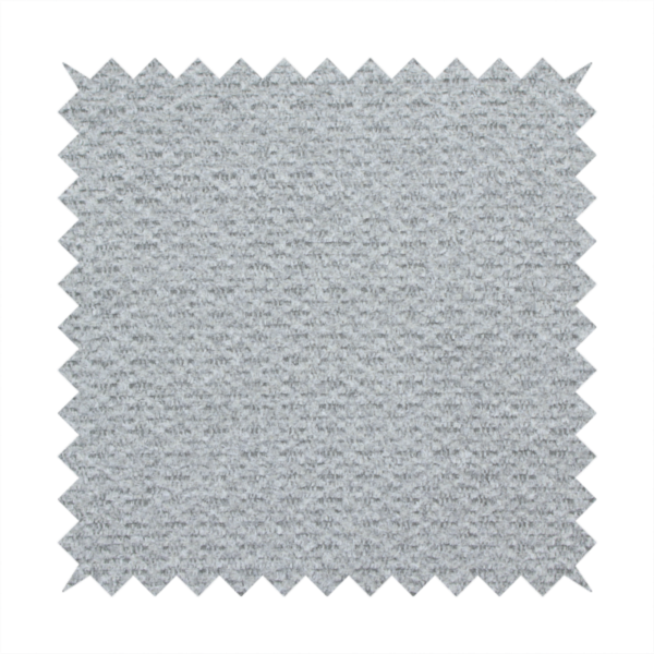 A textured light grey upholstery fabric.