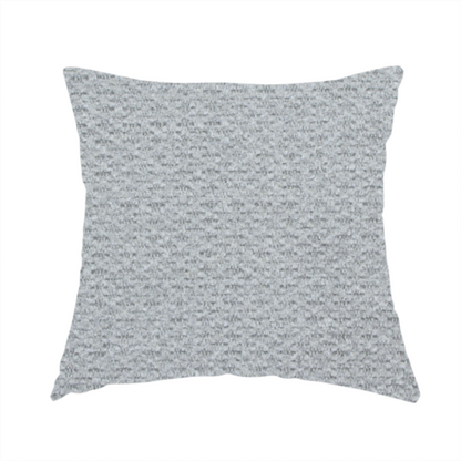 The fabric used to create this handmade cushion is a textured light grey upholstery fabric.