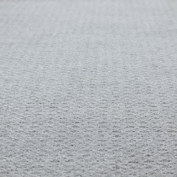 A textured light grey upholstery fabric.