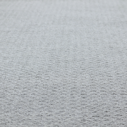 A textured light grey upholstery fabric.