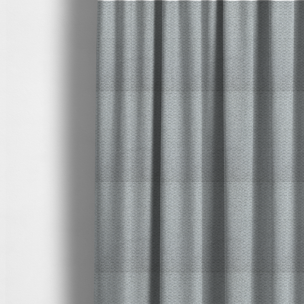 The fabric used to create these made-to-measure curtains is a textured light grey upholstery fabric.
