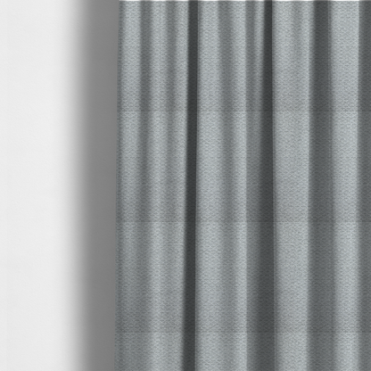 The fabric used to create these made-to-measure curtains is a textured light grey upholstery fabric.