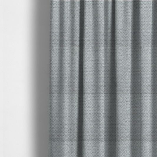 The fabric used to create these made-to-measure curtains is a textured light grey upholstery fabric.
