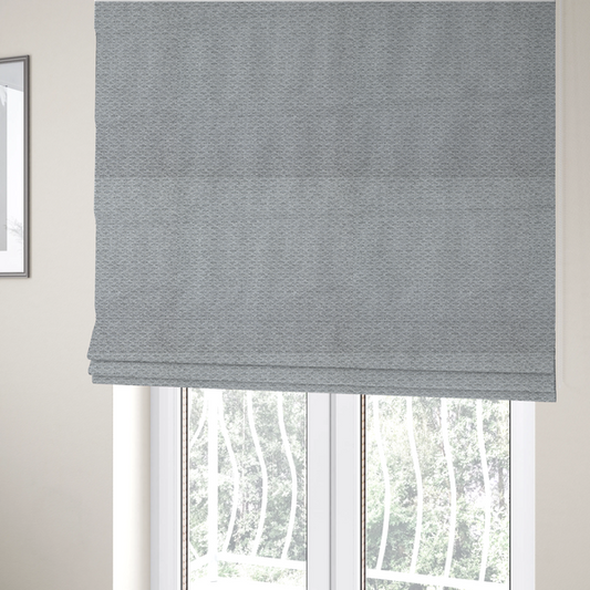 The fabric used to create these Roman blinds is a textured light grey upholstery fabric.
