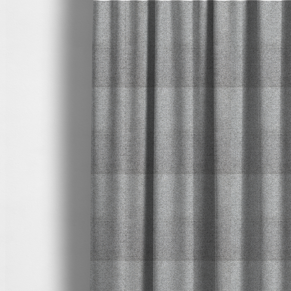 The fabric used to create these made-to-measure curtains is a  textured mid-grey upholstery fabric with a subtle heathered effect.