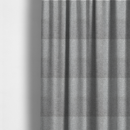 The fabric used to create these made-to-measure curtains is a  textured mid-grey upholstery fabric with a subtle heathered effect.