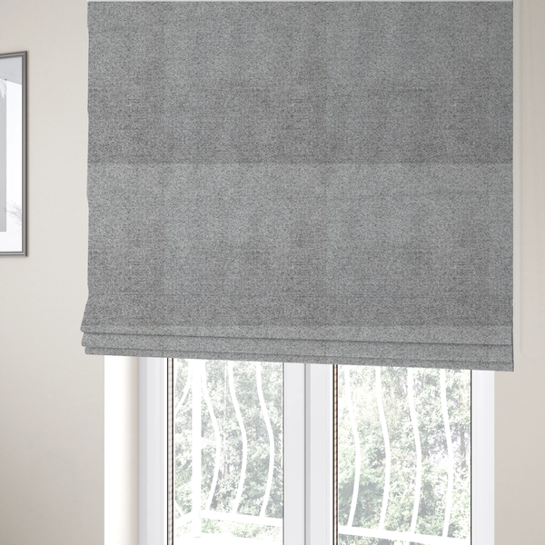The fabric used to create these Roman blinds is a textured mid-grey upholstery fabric with a subtle heathered effect.