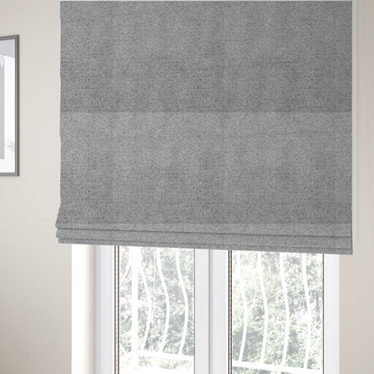 The fabric used to create these Roman blinds is a textured mid-grey upholstery fabric with a subtle heathered effect.