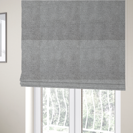 The fabric used to create these Roman blinds is a textured mid-grey upholstery fabric with a subtle heathered effect.