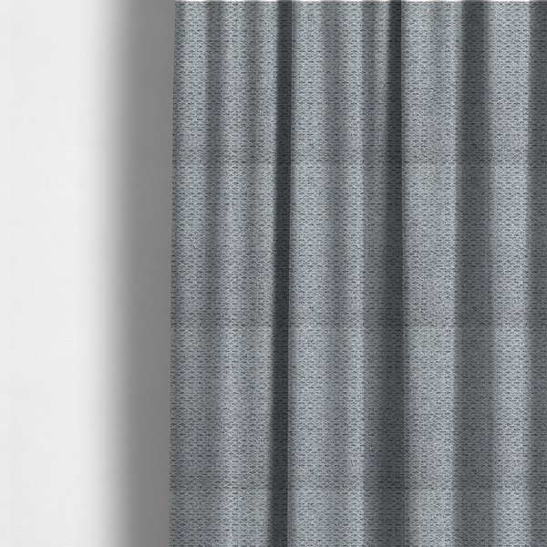 The fabric used to create these made-to-measure curtains is a textured light charcoal grey upholstery fabric with distinct darker horizontal weave lines.