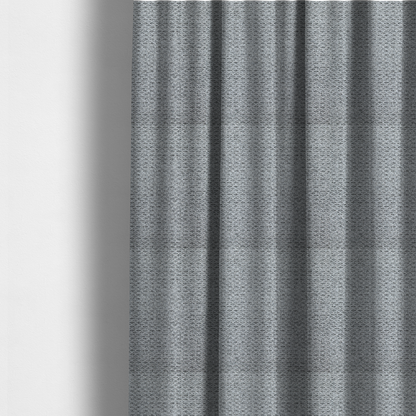 The fabric used to create these made-to-measure curtains is a textured light charcoal grey upholstery fabric with distinct darker horizontal weave lines.