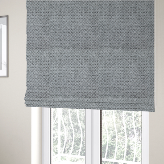 The fabric used to create these Roman blinds is a textured light charcoal grey upholstery fabric with distinct darker horizontal weave lines.