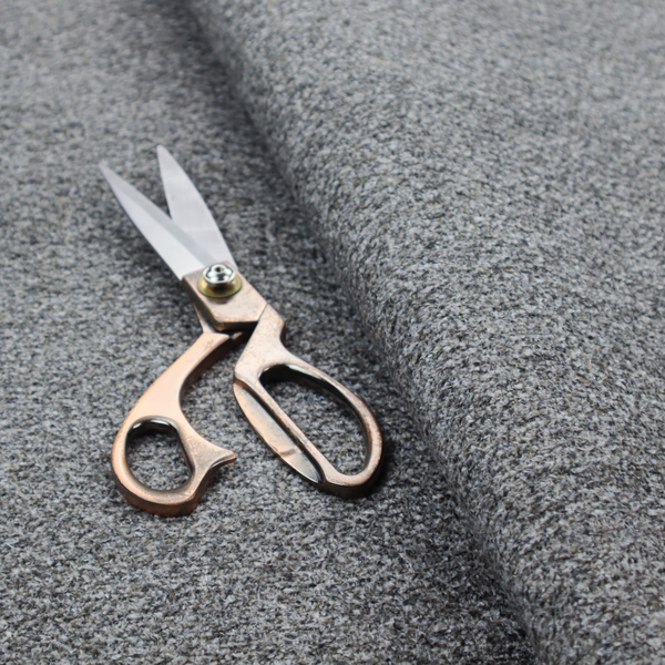 A multi-toned charcoal grey and silver textured upholstery fabric.