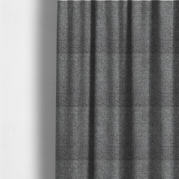The fabric used to create these made-to-measure curtains is a multi-toned charcoal grey and silver textured upholstery fabric.