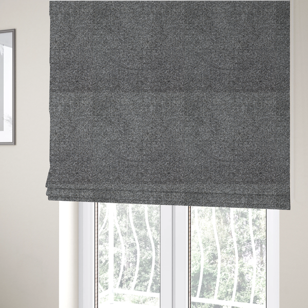 The fabric used to create these Roman blinds is a multi-toned charcoal grey and silver textured upholstery fabric.